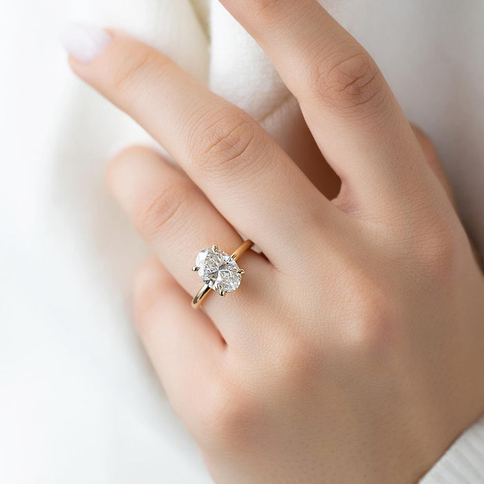 Oval lab grown diamond ring showing the split claw tips and plain fine band