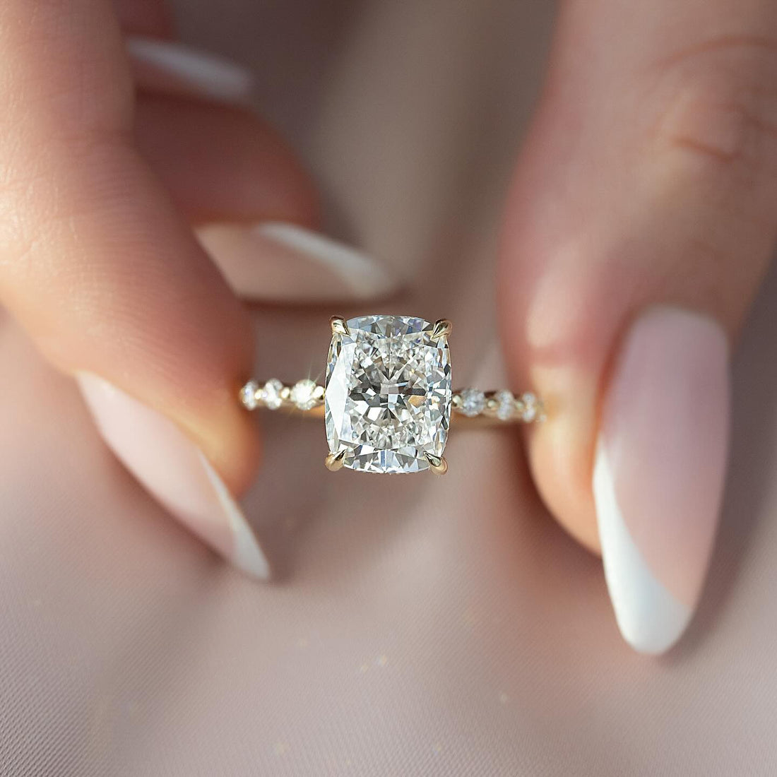 Elongated cushion cut lab grown diamond ring in yellow gold with a shared prong accent shank