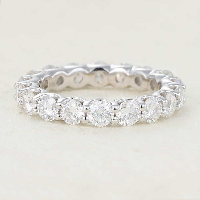 White gold round moissanite full eternity band with U shaped prongs, front view
