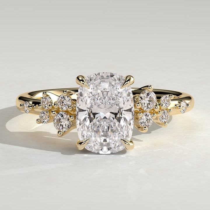 Elongated cushion cut lab grown diamond ring with scattered marquise accents in yellow gold