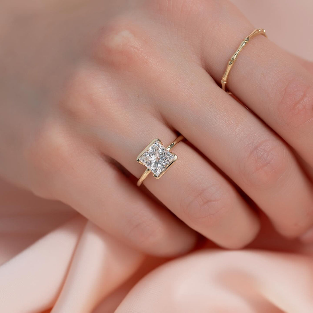 Princess cut lab grown diamond half bezel ring set on the diagonal in yellow gold