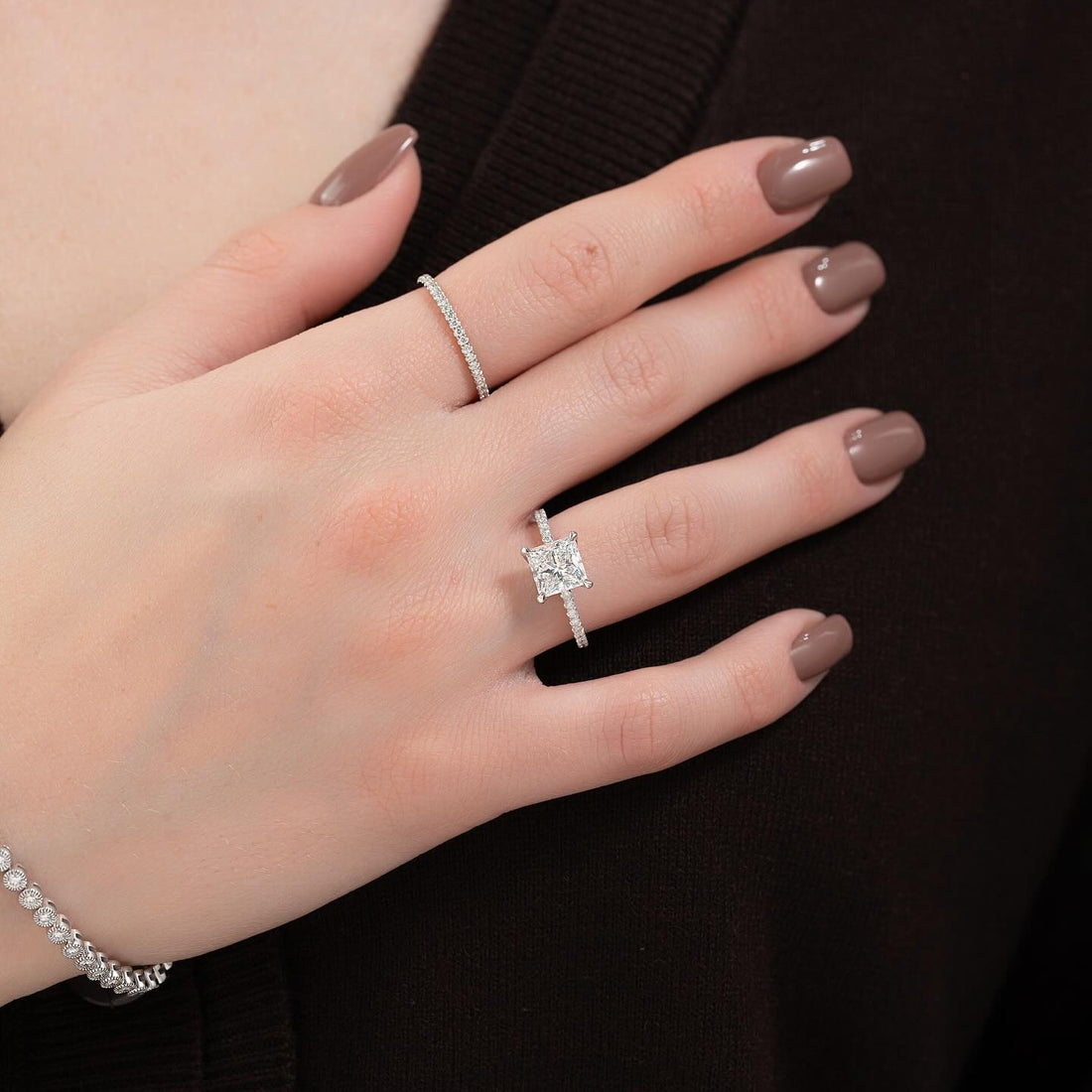 Princess cut lab grown diamond ring with micro pave shank in white gold worn on the hand