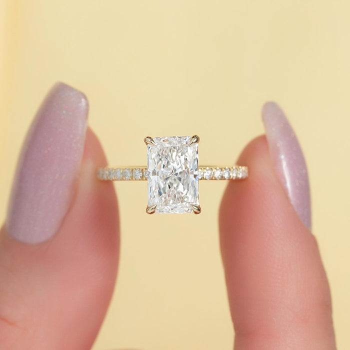Radiant cut lab grown diamond ring on a pave band in yellow gold, front view