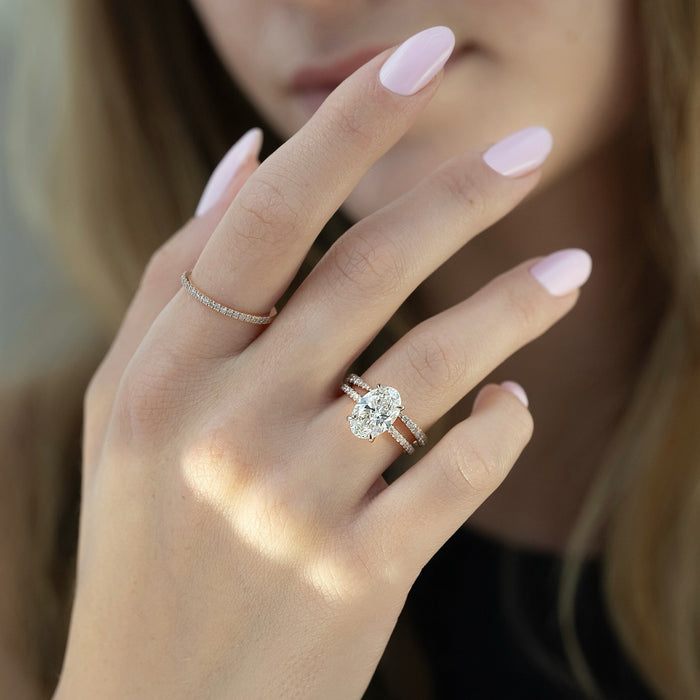 Oval engagement ring and matching pave wedding band worn together
