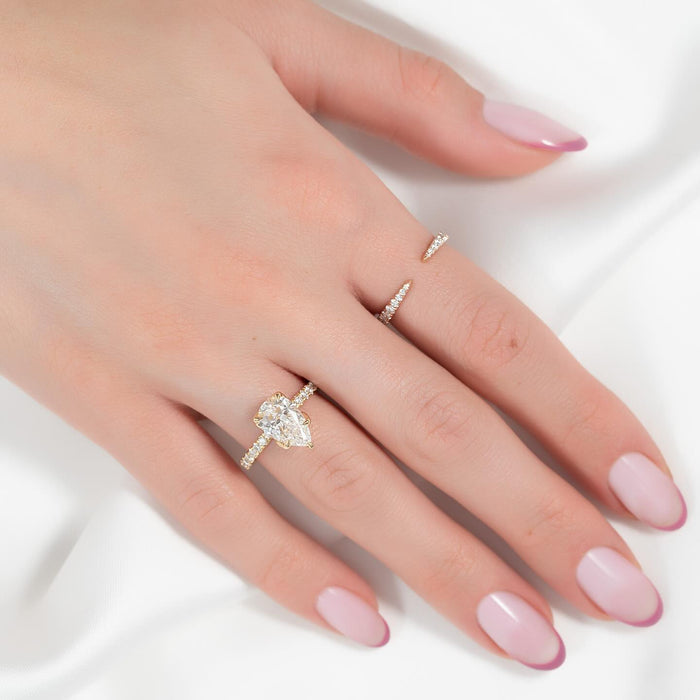 Pear cut lab grown diamond pave band engagement ring worn on the hand