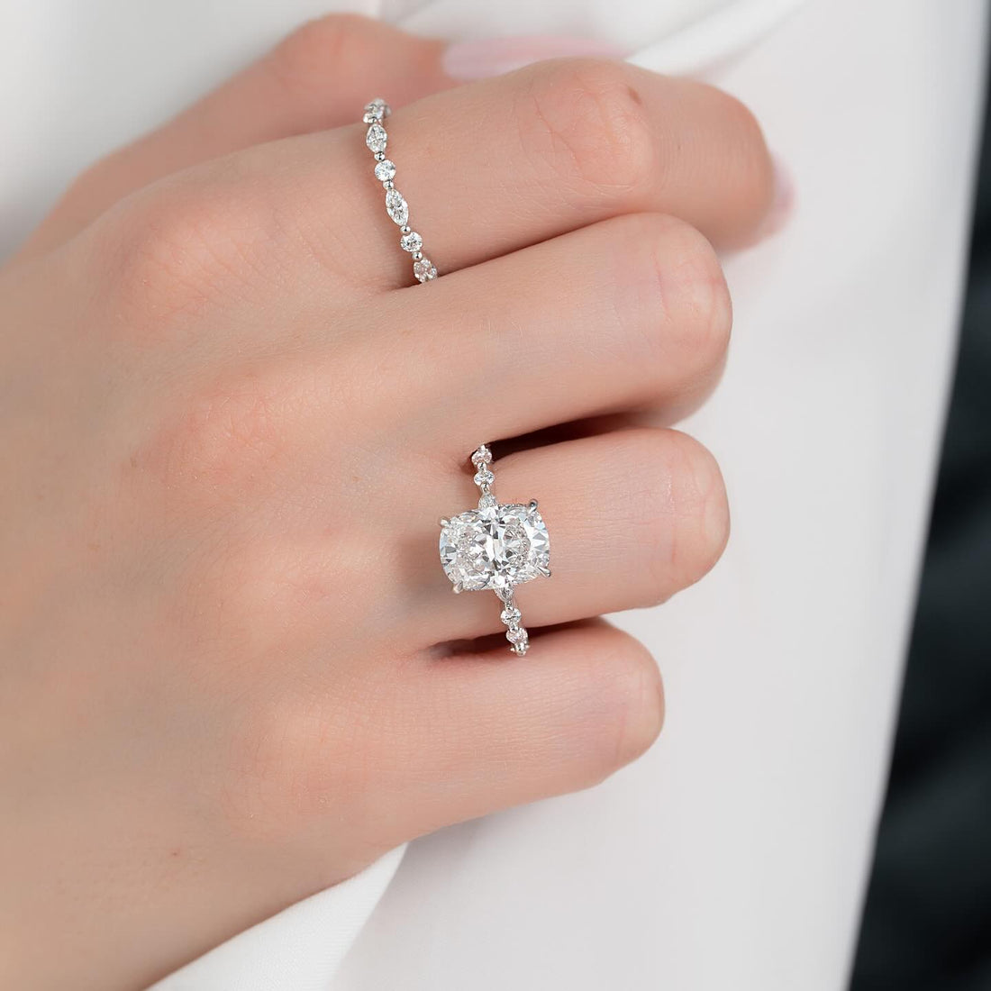 Cushion cut lab grown diamond hidden halo ring in white gold worn on the hand