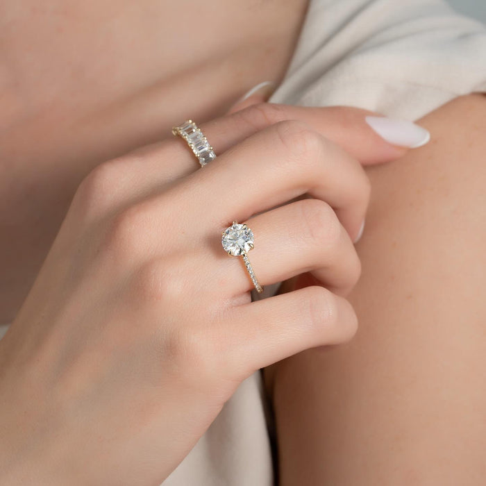 Round diamond engagement ring worn on the hand