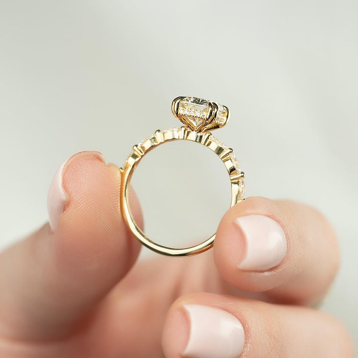 Profile of an elongated cushion cut lab grown diamond ring on a marquise station band in yellow gold