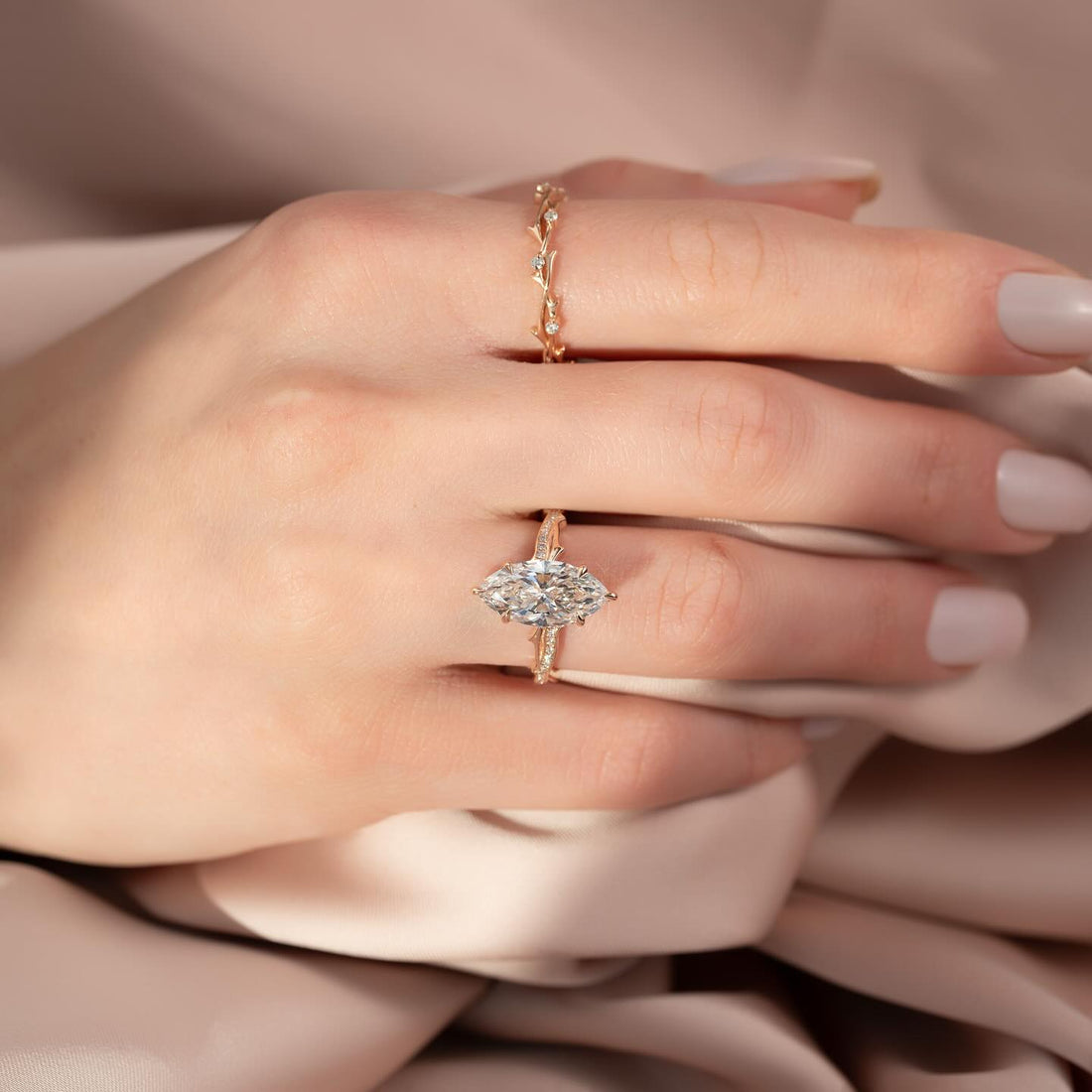 Marquise cut lab grown diamond ring with twisted pave rope band in rose gold worn on the hand