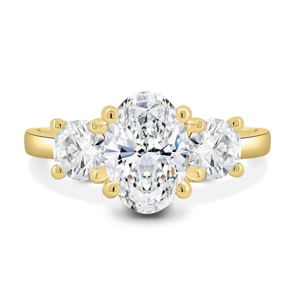 Oval cut lab grown diamond three stone ring with round side stones