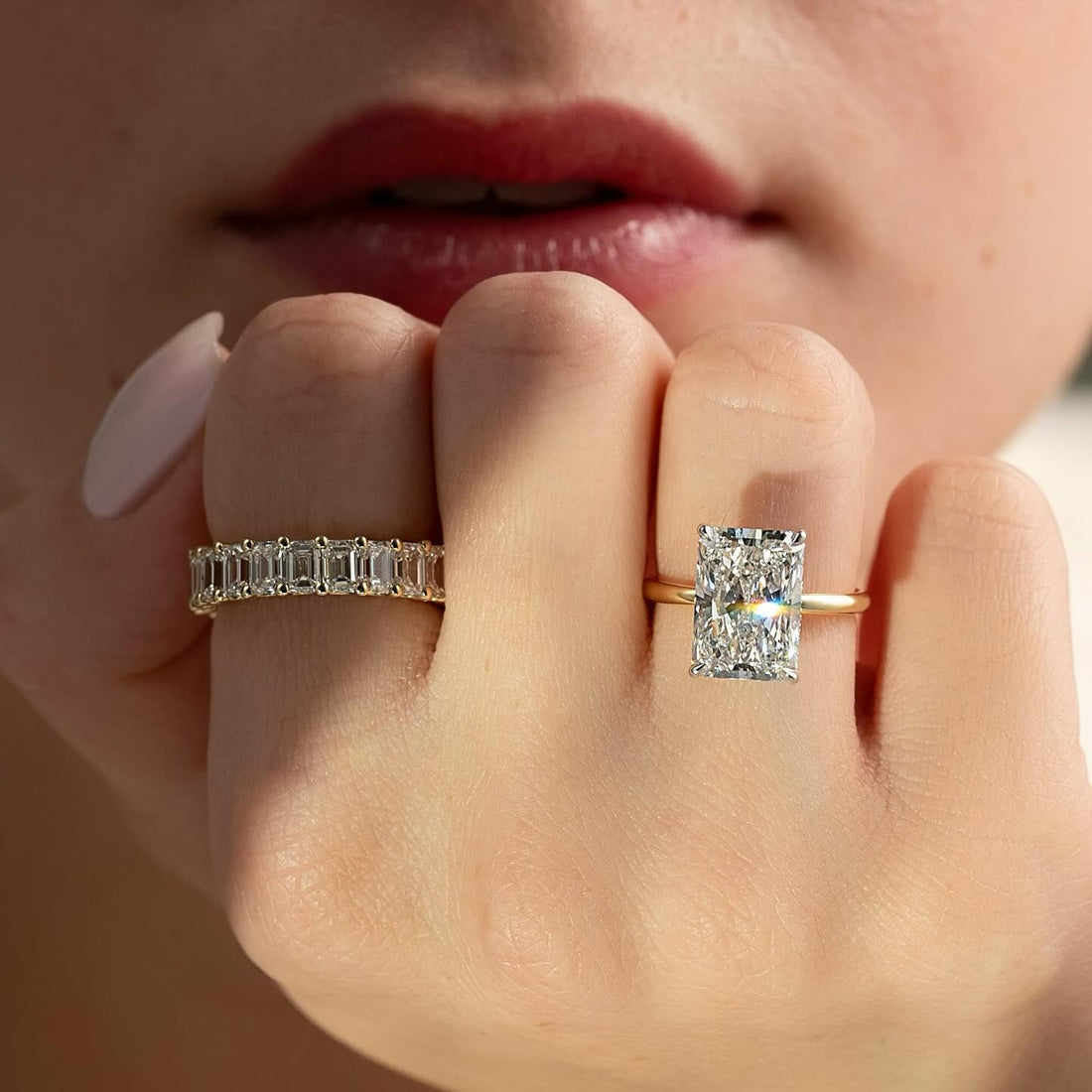 Elongated radiant cut lab grown diamond ring on a slim rounded yellow gold shank