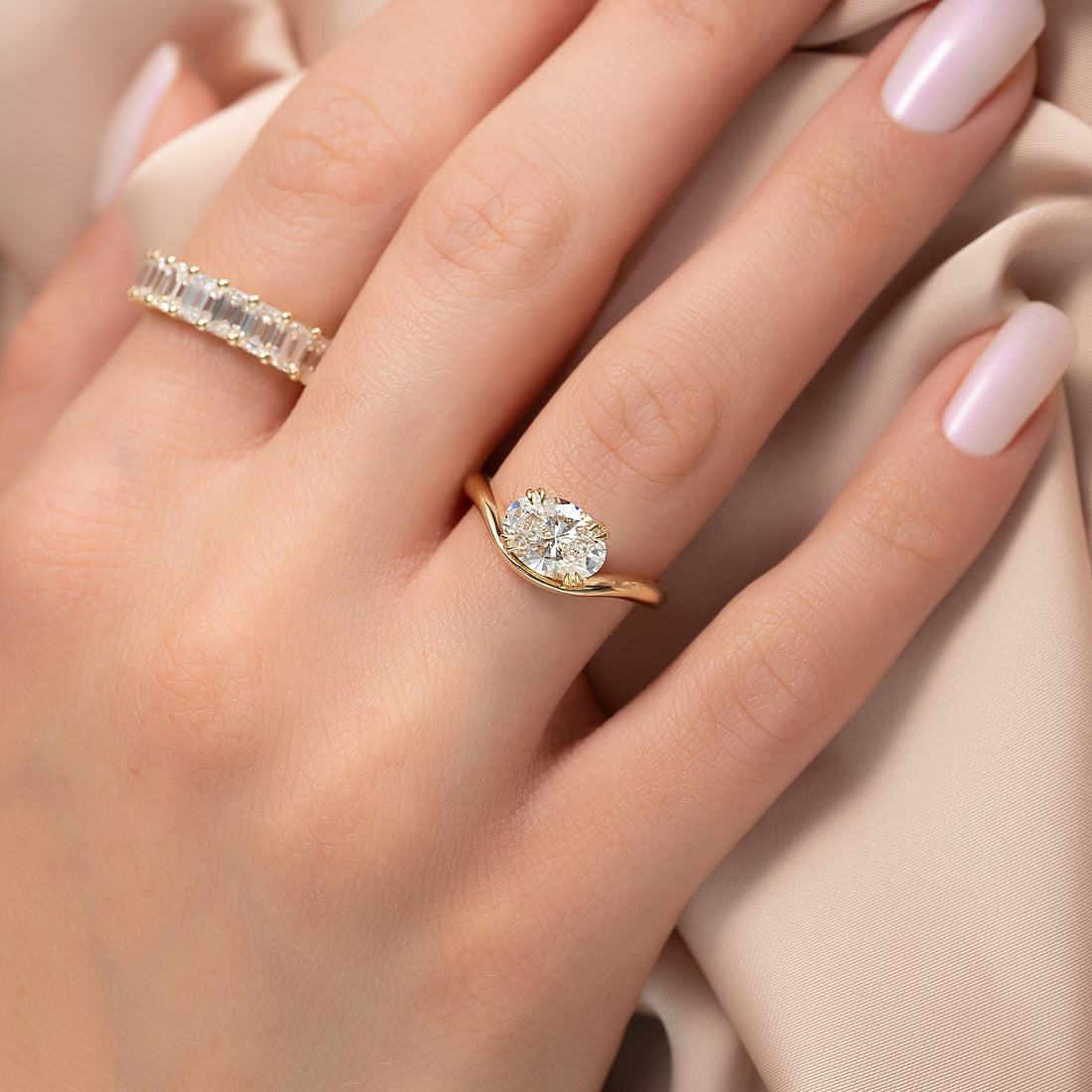 Oval lab grown diamond bypass ring with sweeping twist band in yellow gold
