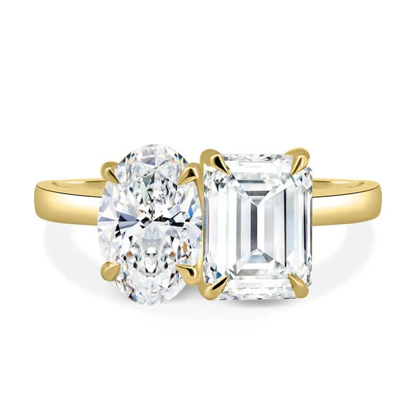 Oval and emerald cut two stone ring shown in a presentation box