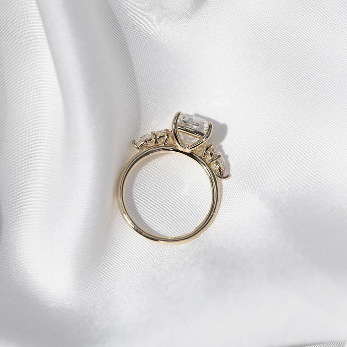 Profile of the cushion cut lab grown diamond ring showing the four claw basket and accent stones