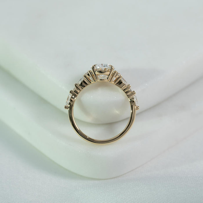 Profile view of the graduated pear and round accent shoulders