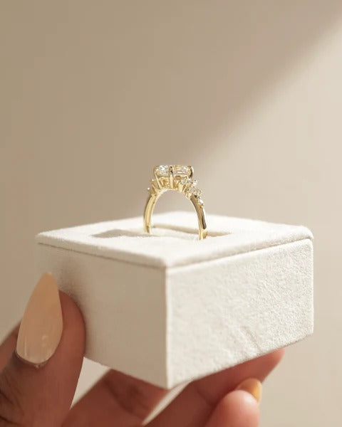 Oval diamond cluster ring scattered accent stone detail