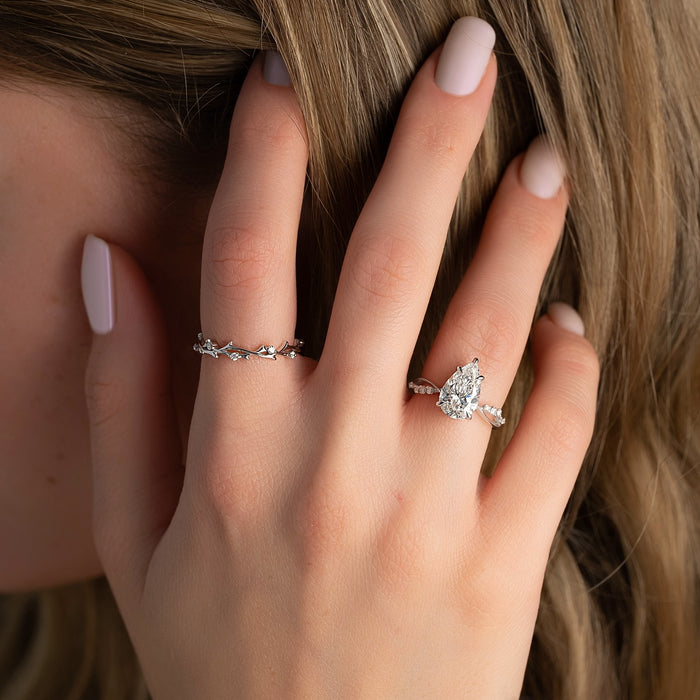 Pear cut diamond engagement ring worn on hand