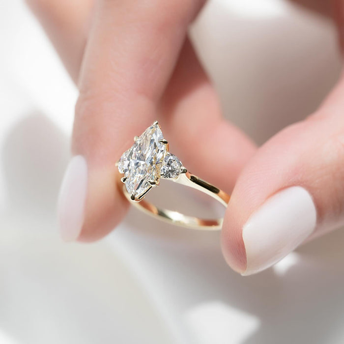 Angled view of the marquise lab grown diamond ring with heart shaped side diamonds