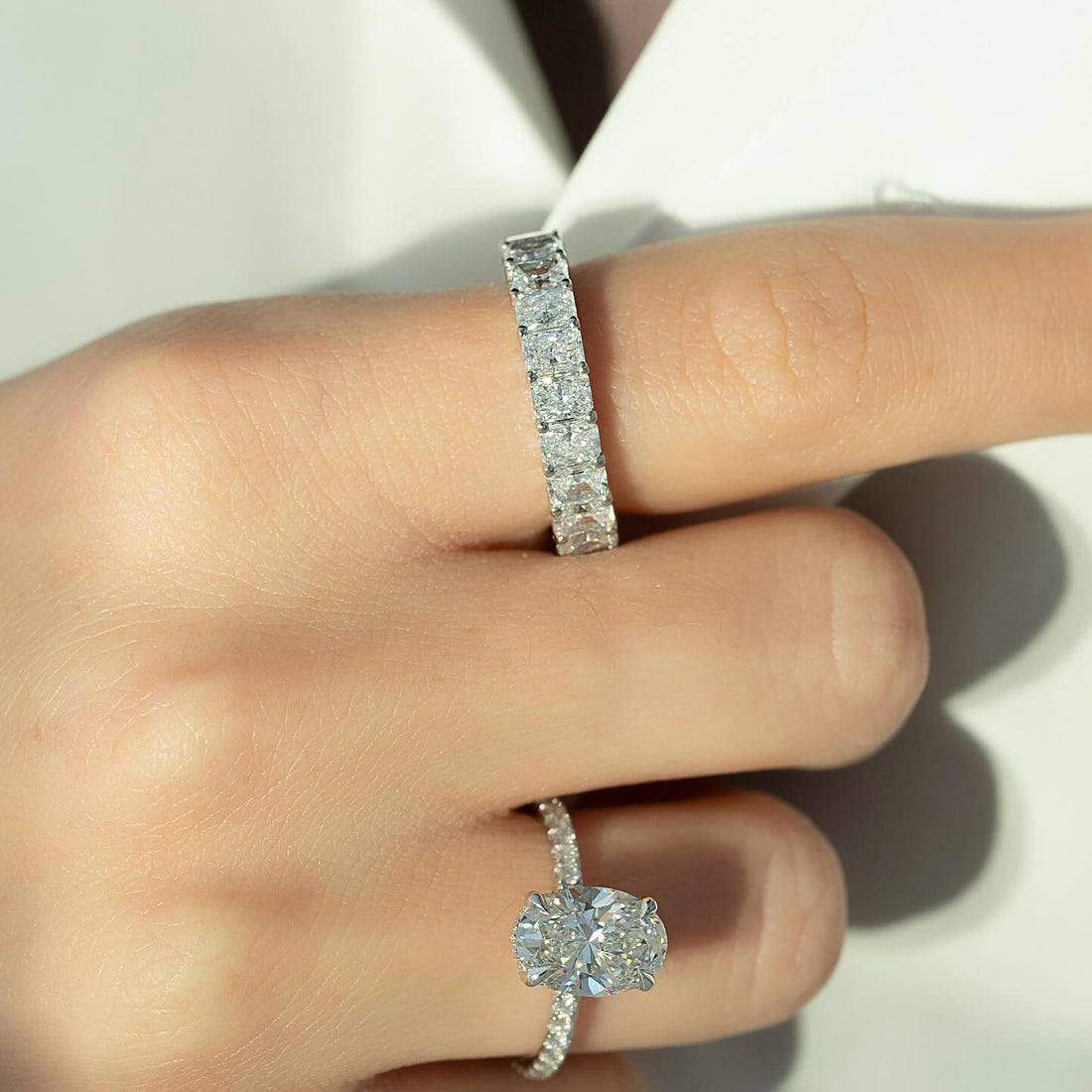 Oval cut lab grown diamond ring with hidden halo on a fully pave set white gold shank
