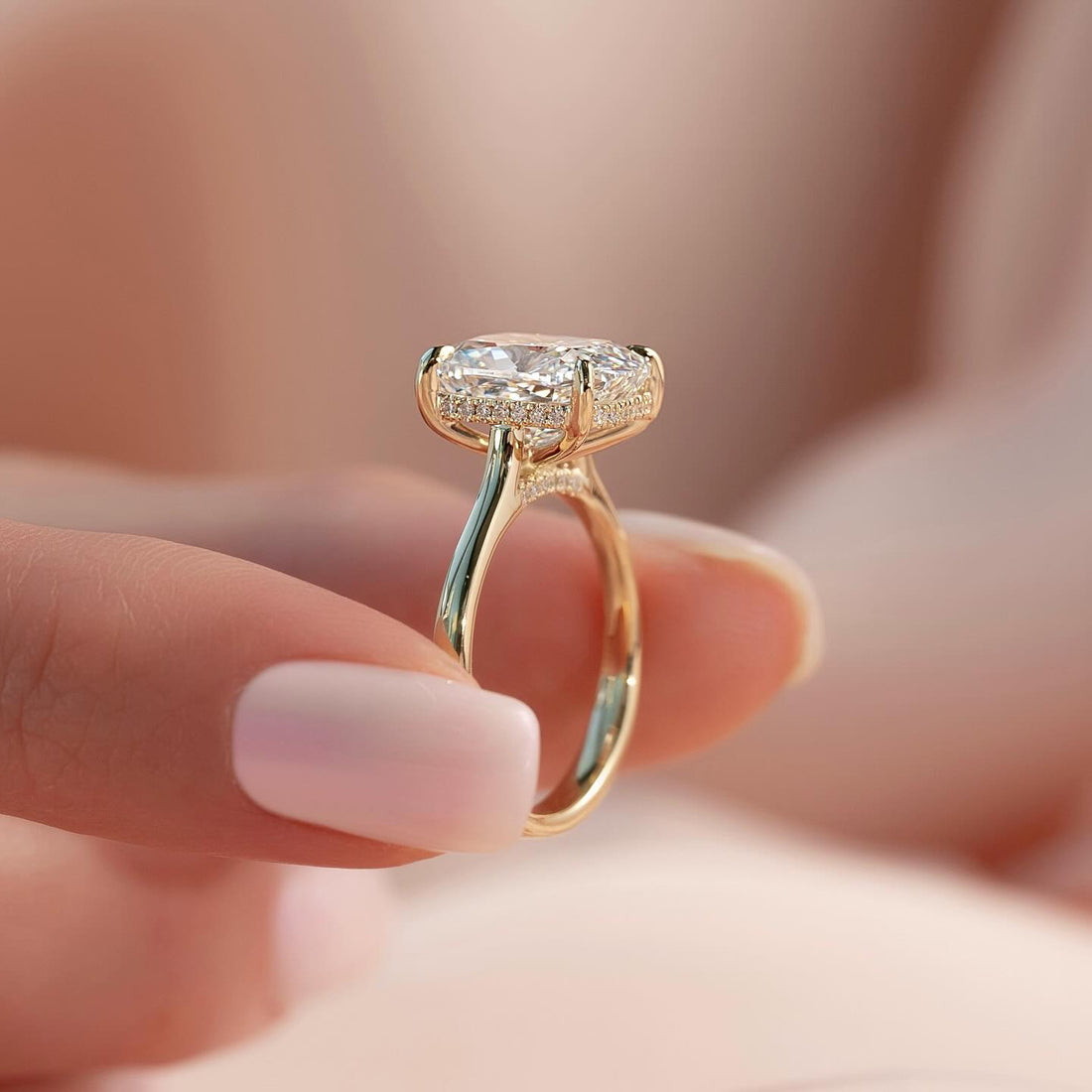 East west elongated cushion lab grown diamond ring with hidden halo on a cathedral shank