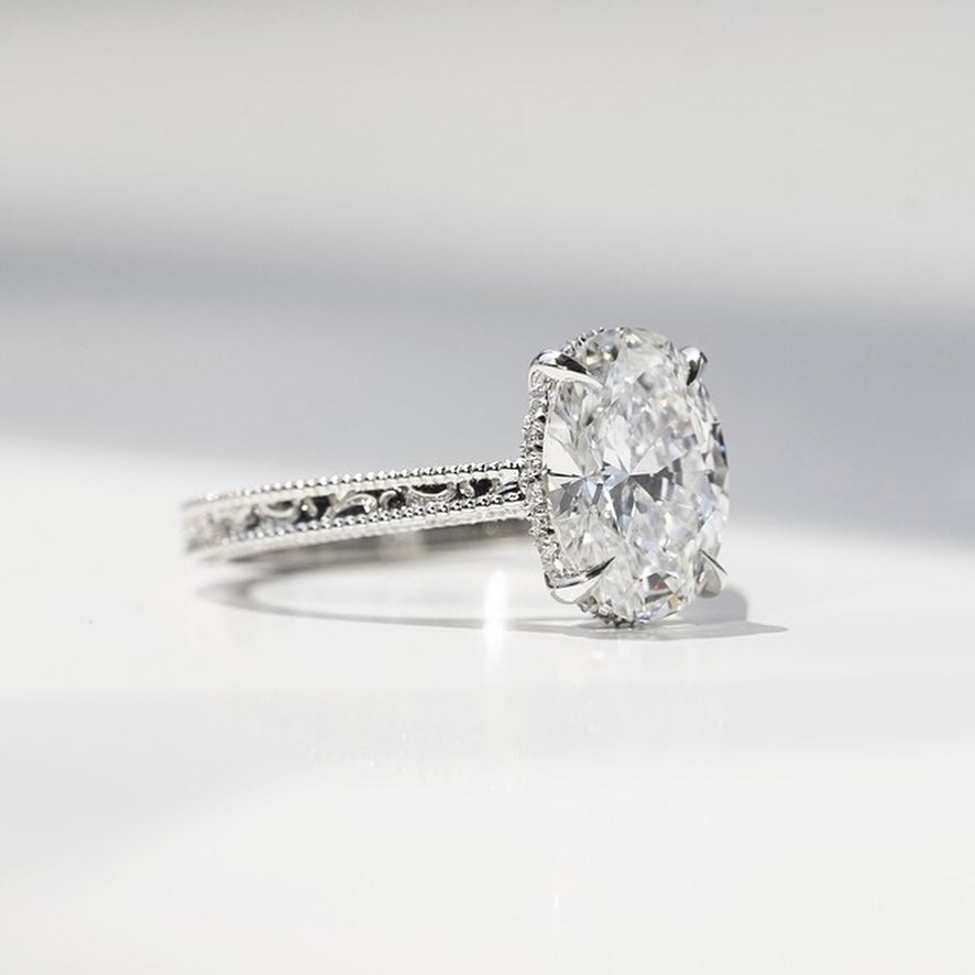 Oval cut lab grown diamond ring in white gold with hand engraved scroll shoulders