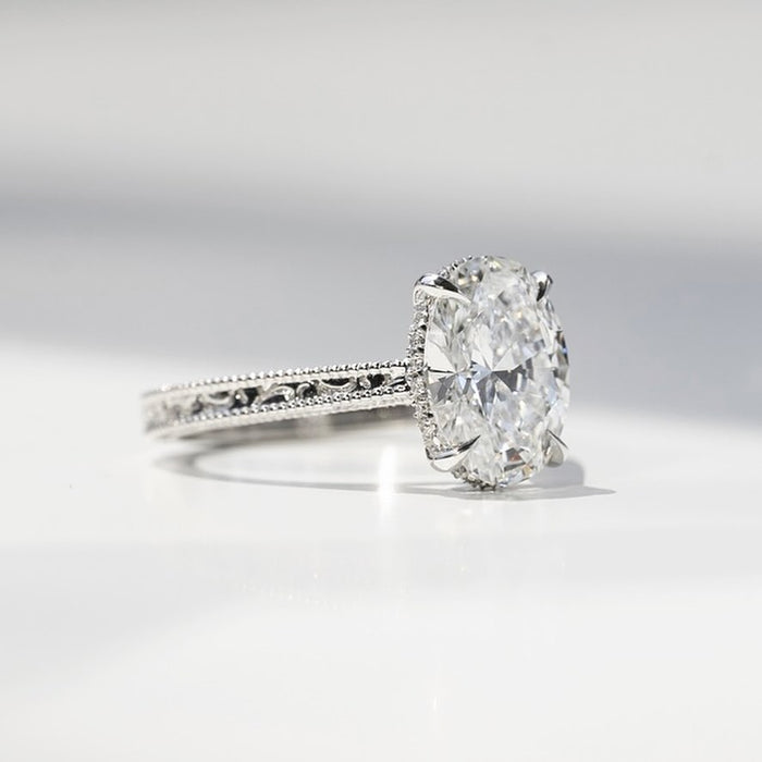 Oval cut lab grown diamond ring in white gold with hand engraved scroll shoulders