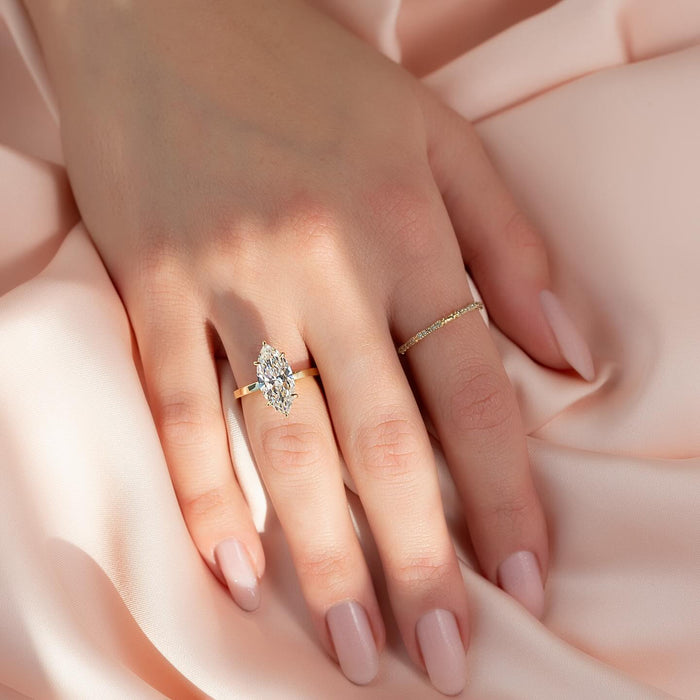 Marquise diamond solitaire engagement ring worn on hand