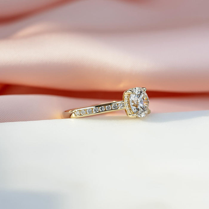 Bright cut pave detail along the shoulder of the round diamond ring