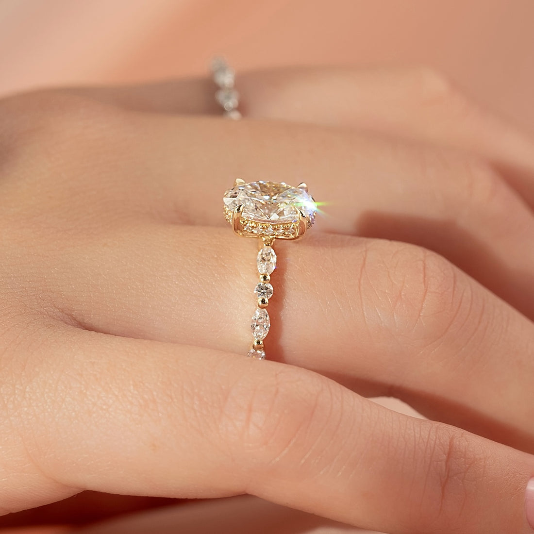 Oval lab grown diamond ring with alternating marquise and round diamond band in yellow gold