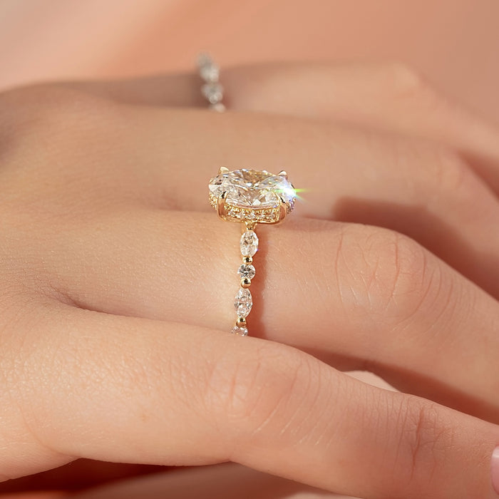 Oval lab grown diamond ring with alternating marquise and round diamond band in yellow gold