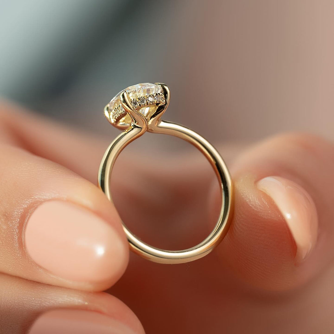 Pear cut lab grown diamond ring with hidden halo on a fine yellow gold band