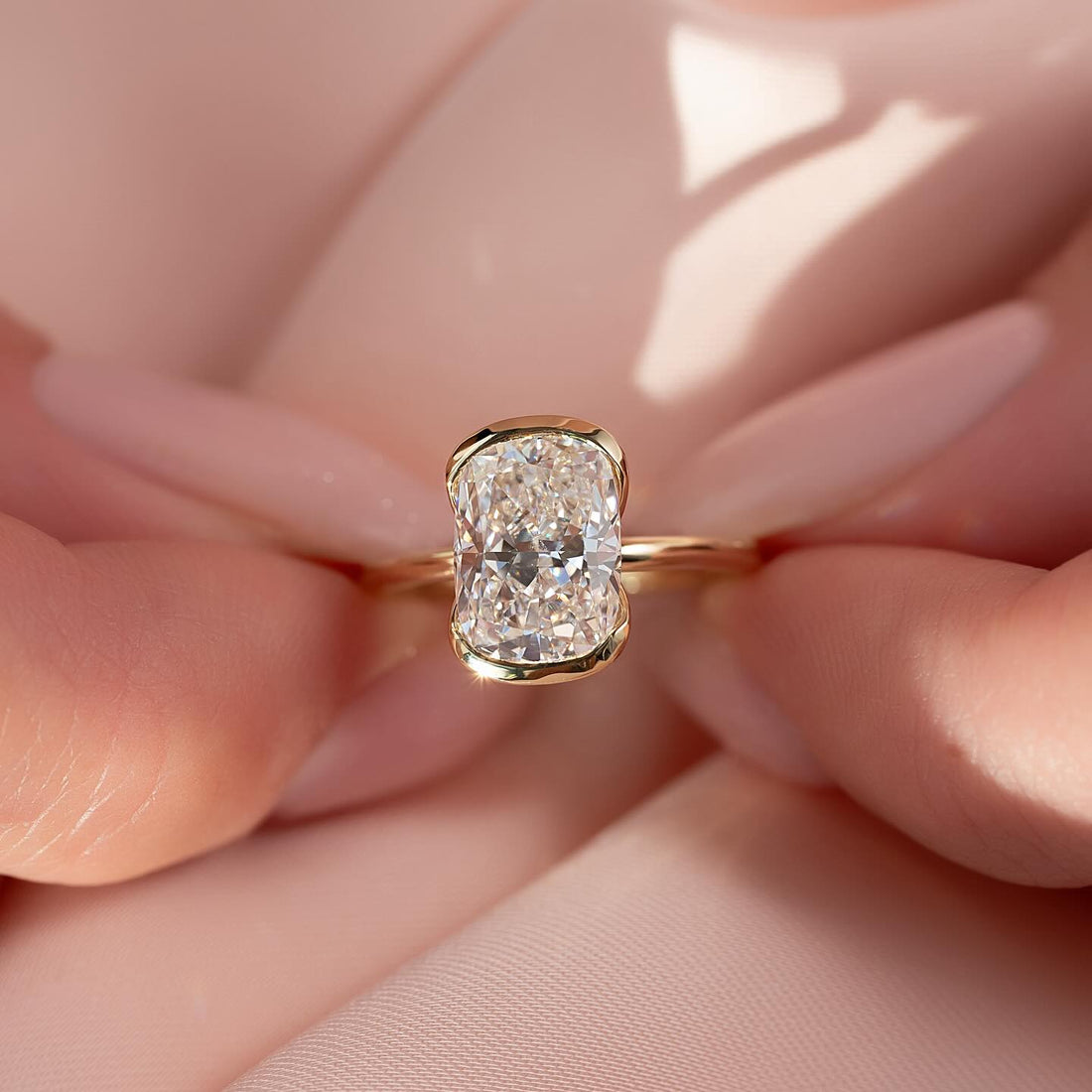 Elongated cushion cut lab grown diamond ring in yellow gold half bezel setting