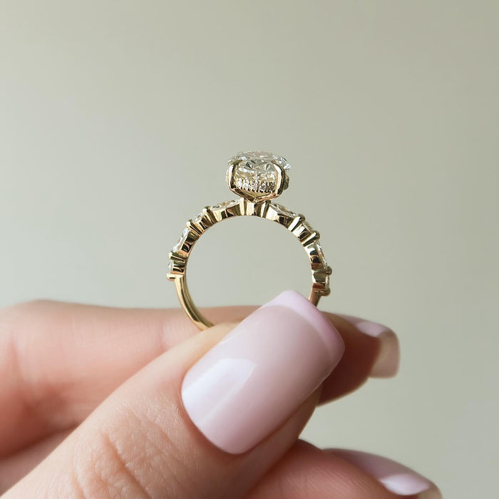 Profile of the oval lab grown diamond ring showing the concealed halo and individually set accents