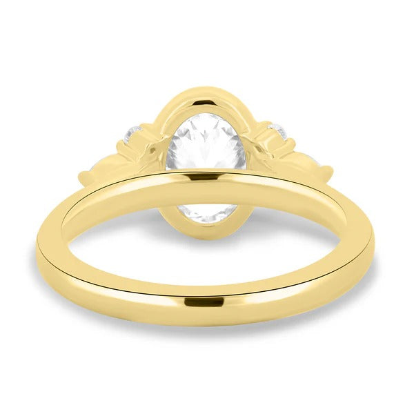 Floating pear and round accent cluster beside bezel set oval