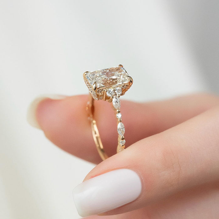 Close view of the trefoil accent clusters beside the radiant cut diamond