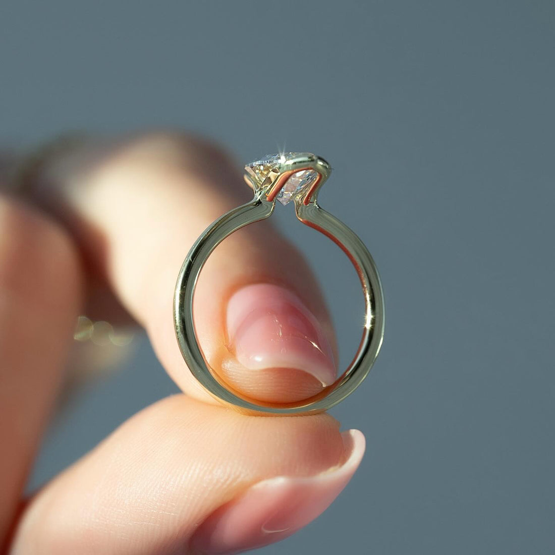 Marquise cut lab grown diamond ring in a two claw V tip setting on a fine yellow gold band