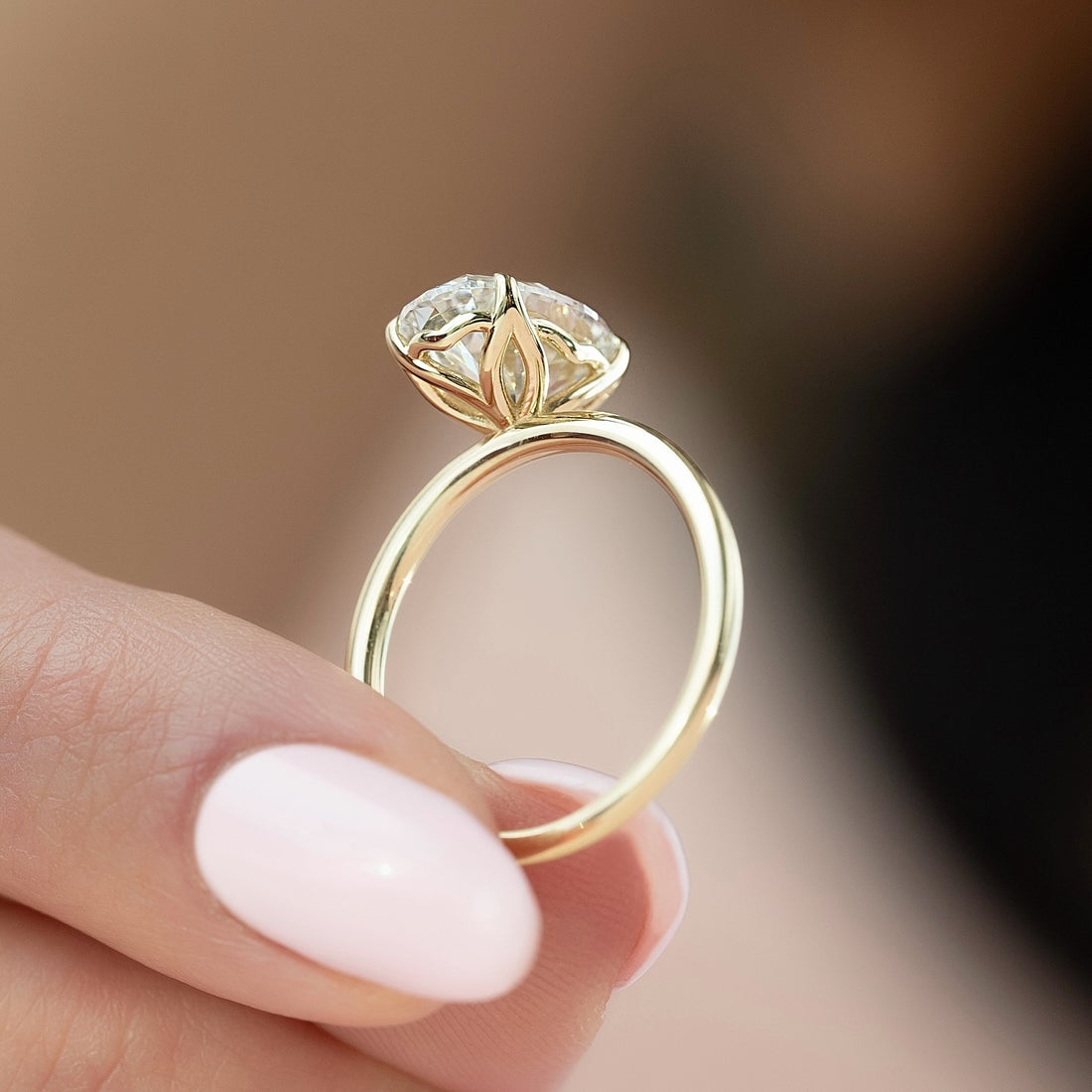 Round brilliant cut lab grown diamond ring in a lotus claw setting in yellow gold