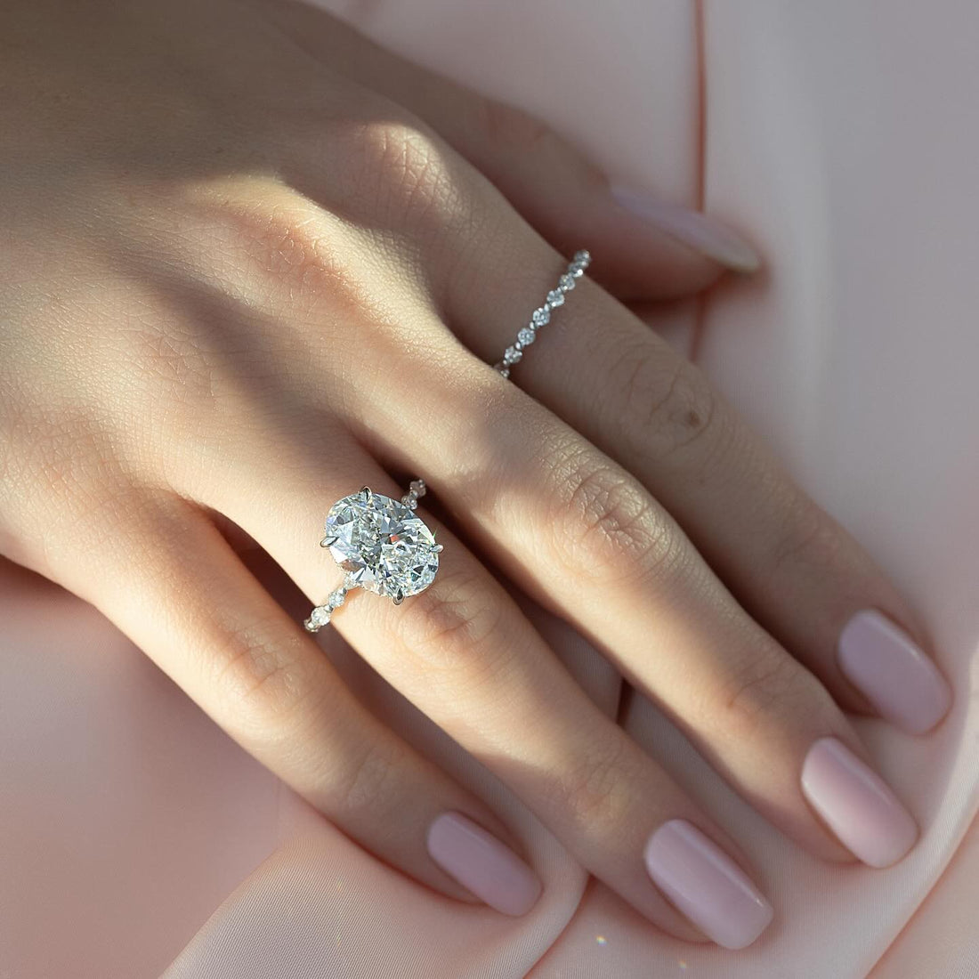Oval cut lab grown diamond ring with hidden halo and alternating marquise and round shoulders in white gold