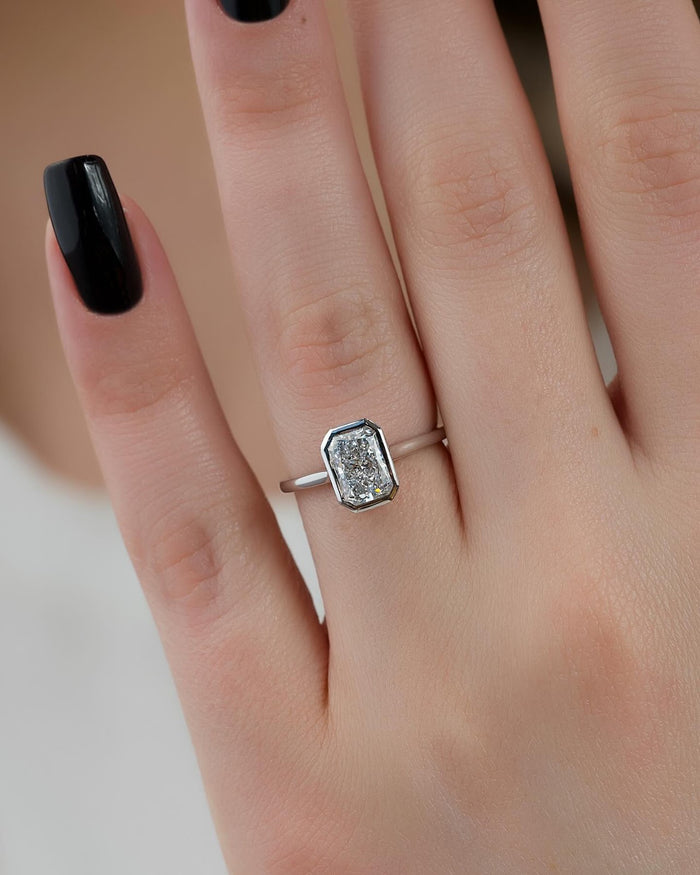 Radiant cut lab grown diamond ring showing the domed pave across the band