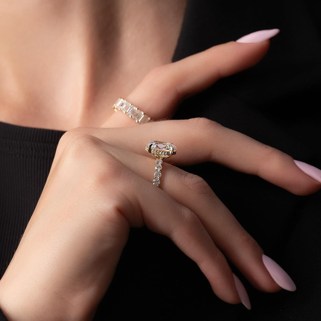 East west oval cut lab grown diamond ring with hidden halo and graduated shank in yellow gold