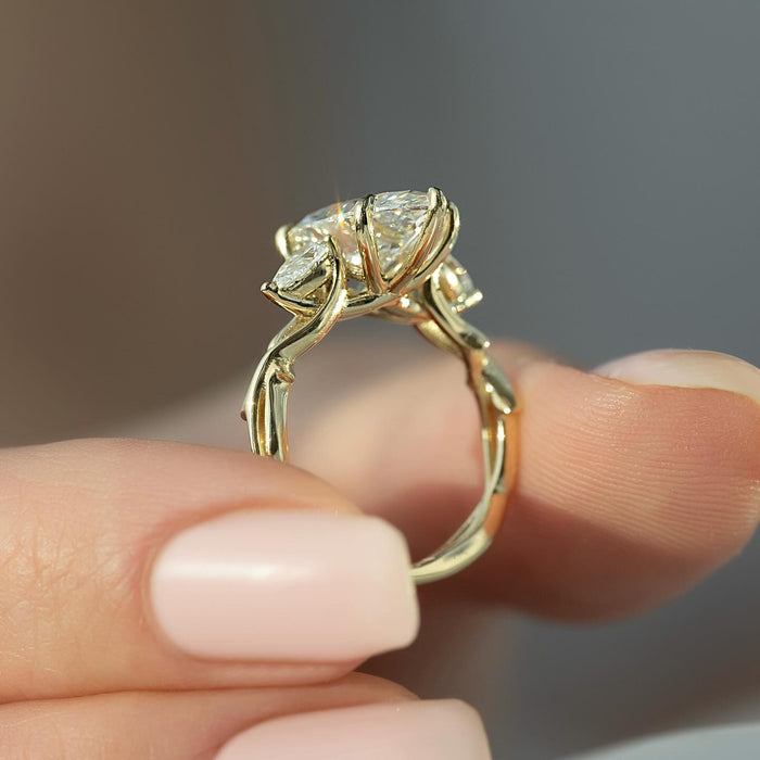 Pear cut side stones beside the east west marquise diamond