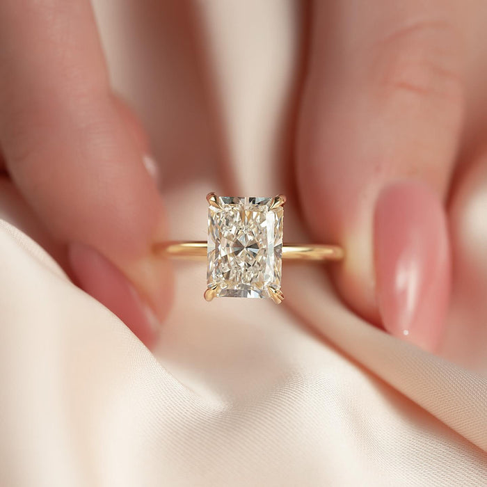 Radiant cut diamond solitaire viewed from above on a fine gold band