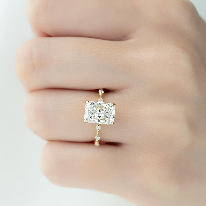 Radiant cut lab grown diamond ring in yellow gold on a collared segment band