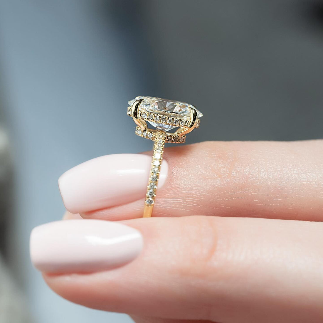 Profile of an oval cut lab grown diamond ring showing the double concealed halo in yellow gold