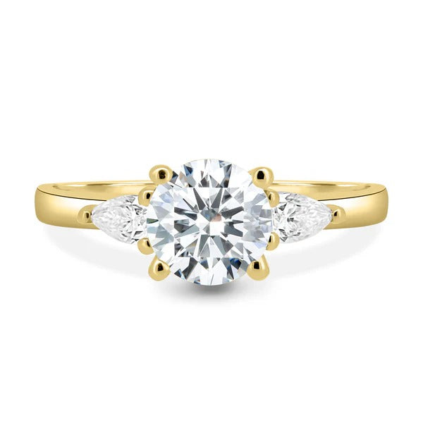 Round cut lab grown diamond three stone trellis ring with pear side stones
