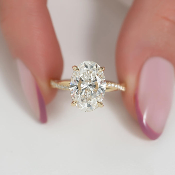 Oval cut lab grown diamond ring on a twisted pave band in yellow gold, front view
