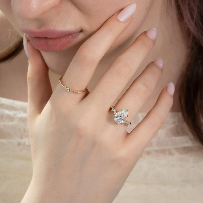 Pear cut lab grown diamond ring with graduated spaced diamond accents in yellow gold