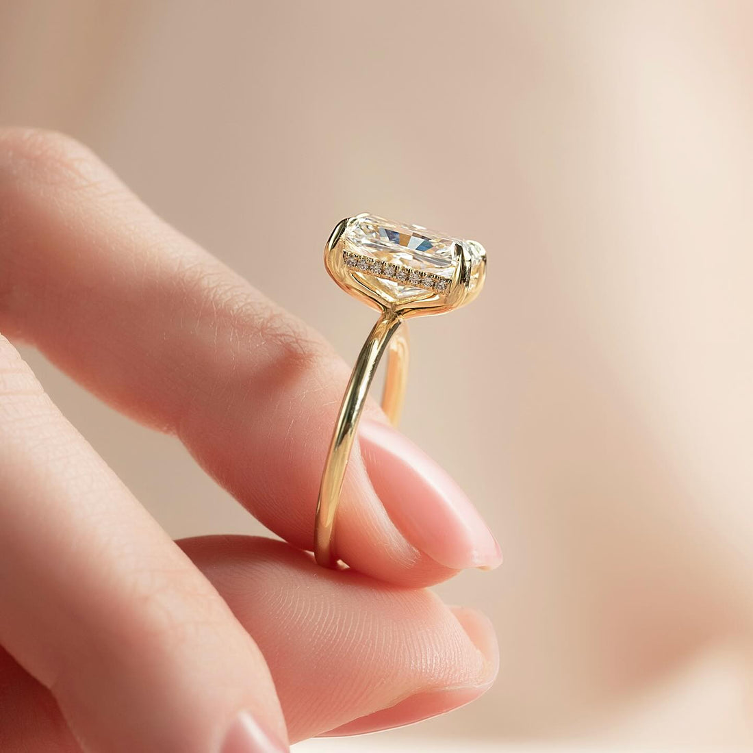 Radiant cut lab grown diamond ring with hidden halo on a knife thin yellow gold band