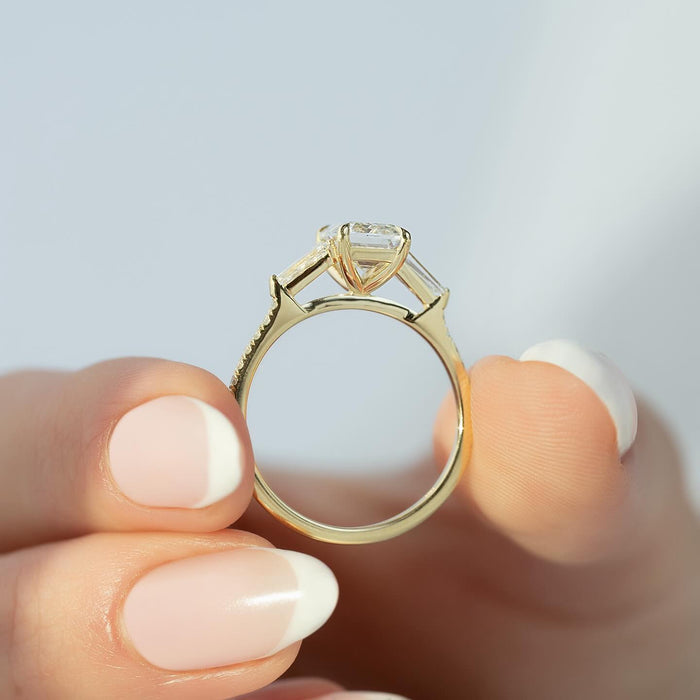 Profile of the emerald cut ring showing the tapered baguettes and the open gallery