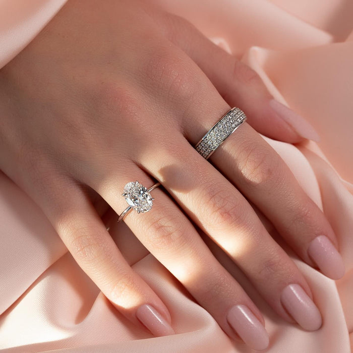 Long tapered claws gripping the oval lab grown diamond